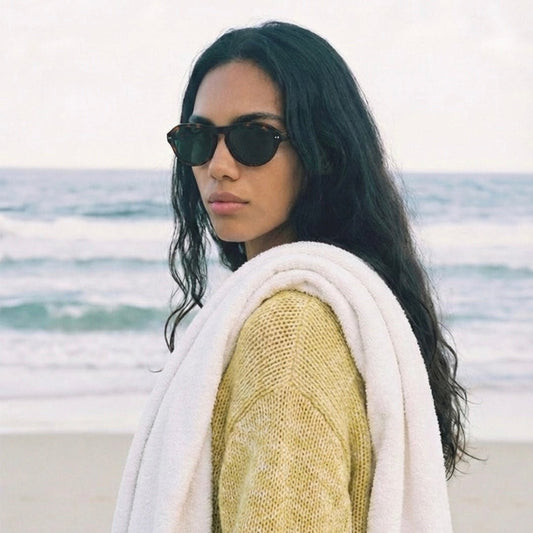 Model wearing Ciren oval tortoiseshell sunglasses, front view zoomed out