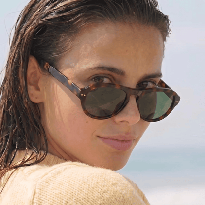 Model wearing Ciren oval tortoiseshell sunglasses, slightly lowered on nose bridge